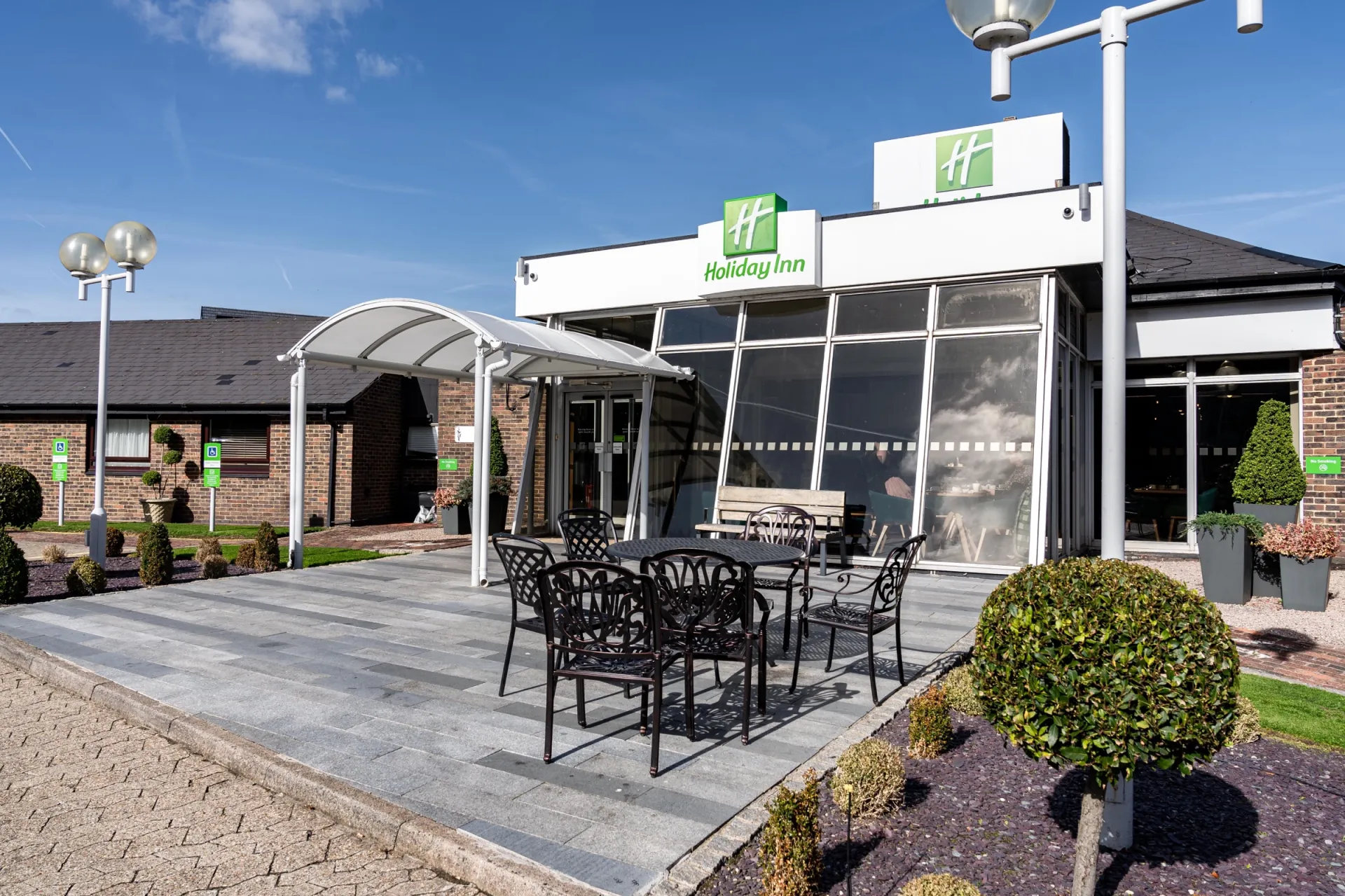 Holiday Inn Dover entrance with outdoor seating under a canopy