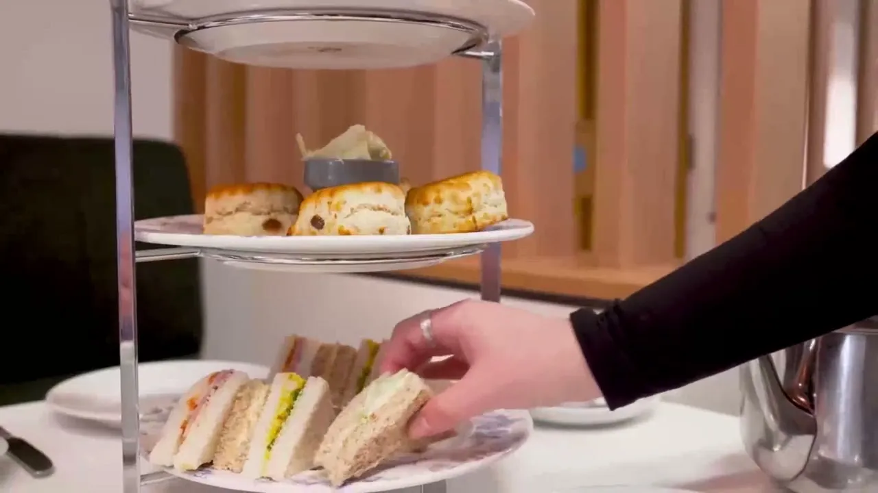 Afternoon tea stand with scones and finger sandwiches