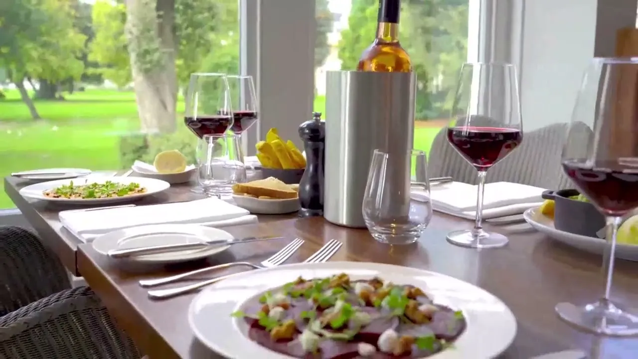 A table set with red wine on the lawn at Holiday Inn Dover