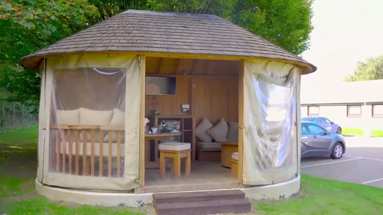 The round Garden Hideaway pod on the lawn with its sides rolled up