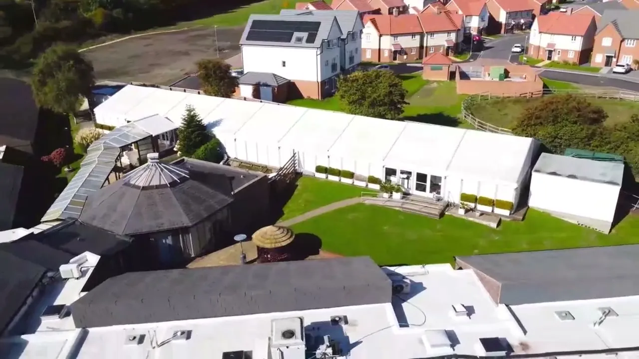 Drone view of Holiday Inn Dover's lawns and the round Garden Hideaway pod